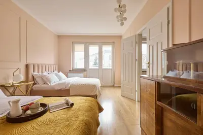a hotel room with two beds and a television at Polka Apartment 2-bed in Kraków