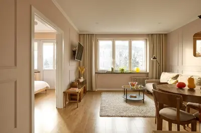 a living room with a couch and a table at Polka Apartment 2-bed in Kraków