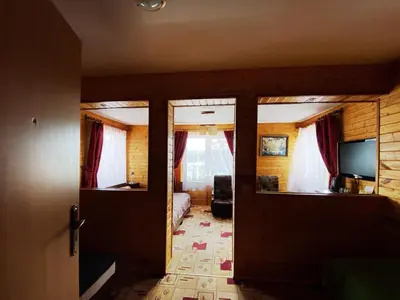 a room with a bedroom with a bed and windows at Willa Światowid in Rabka