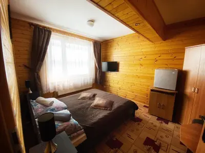 a bedroom with a bed and a television in it at Willa Światowid in Rabka