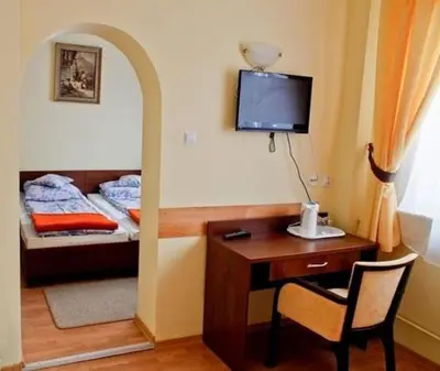 a room with a desk and a bed with a desk at Willa Światowid in Rabka