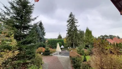 a garden with trees and a tent in the distance at Willa Światowid in Rabka
