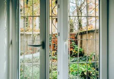 an open window with a view of a building at Cosy Apartment in Kraków
