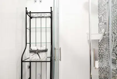 a bathroom with a iron gate with a basket on it at Cosy Apartment in Kraków