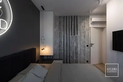 a bedroom with a bed and a shower at Apartamenty Premium New in Wadowice