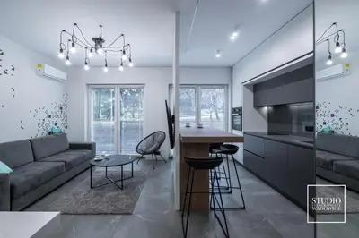 a kitchen and living room with a couch and a table at Apartamenty Premium New in Wadowice