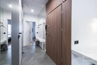 a hallway with wooden cabinets and a hallway with a hallway at Apartamenty Premium New in Wadowice
