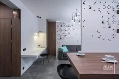 a kitchen and living room with a dining table and a bathroom at Apartamenty Premium New in Wadowice