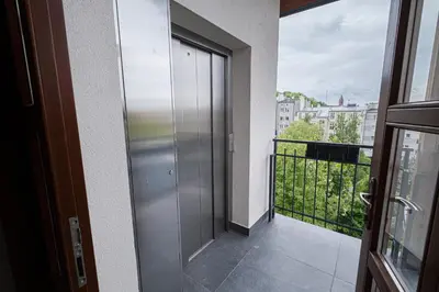 a door to a balcony with a view of a city at Old Town Vistula Premium Apartments in Kraków