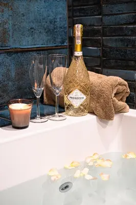 a bottle of wine and two wine glasses on a table at Old Town Vistula Premium Apartments in Kraków