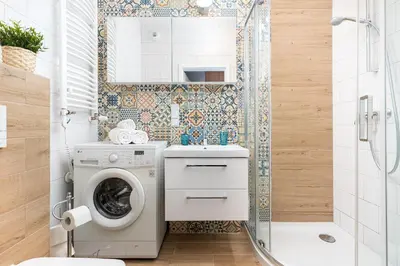 a bathroom with a washing machine and a shower at STEAM PARK Krakow Apartment in Kraków