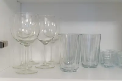 a group of wine glasses sitting on a counter at STEAM PARK Krakow Apartment in Kraków
