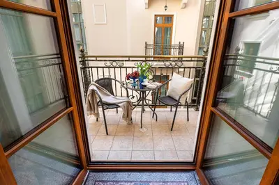 a balcony with a table and chairs on a balcony at Ventus Rosa Boutique Aparthotel in Kraków