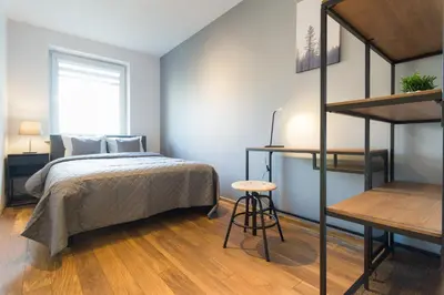 a bedroom with a bed and a loft bed at Wodna Street Big Family Apartment in Kraków