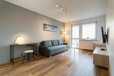 a living room with a couch and a table at Wodna Street Big Family Apartment in Kraków
