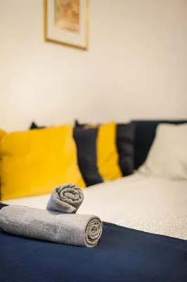 a towel laying on top of a bed at Vintage Krasińskiego 7/4 Apartment in Kraków