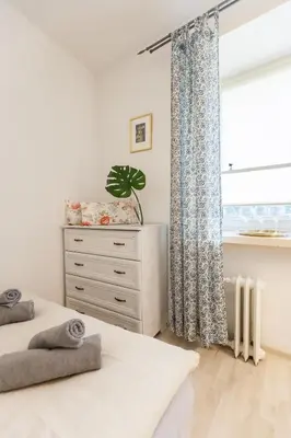 a bedroom with two beds and a window at Vintage Krasińskiego 7/4 Apartment in Kraków