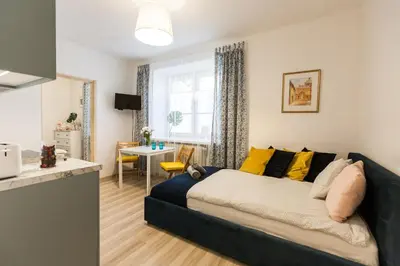 a bedroom with a bed with yellow pillows at Vintage Krasińskiego 7/4 Apartment in Kraków