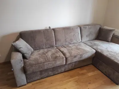 a brown couch sitting in a living room at Appartement Nowa Huta in Kraków