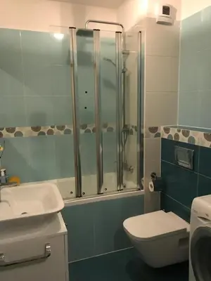 a bathroom with a shower and a toilet and a sink at Appartement Nowa Huta in Kraków