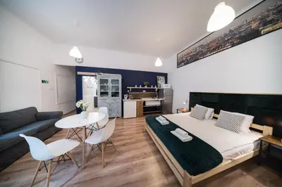 a bedroom with a bed and a table and chairs at Roller Aparthotel in Kraków