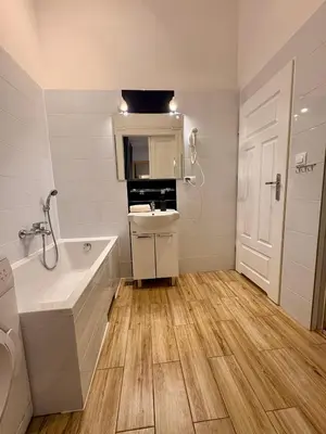 a bedroom with a table and chairs and a bed at Roller Aparthotel in Kraków