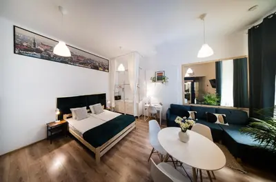 a living room with a couch and a table at Roller Aparthotel in Kraków