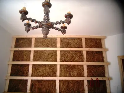 a chandelier hanging over a window with hay at Apartamenty Lili & Country in Kraków