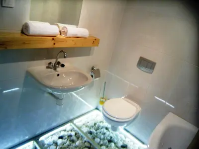 a bathroom with a sink and a toilet at Apartamenty Lili & Country in Kraków