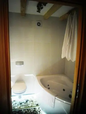 a bathroom with a tub and a toilet and a sink at Apartamenty Lili & Country in Kraków