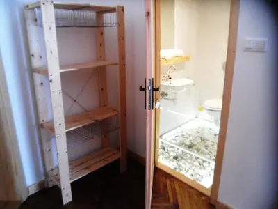 a bathroom with a toilet and a glass door at Apartamenty Lili & Country in Kraków