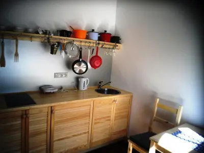 a kitchen with a sink and a counter with utensils at Apartamenty Lili & Country in Kraków