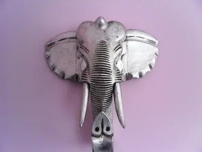 a metal elephant head hanging on a wall at Apartamenty Lili & Country in Kraków
