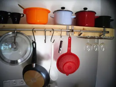 a kitchen with utensils hanging from a rack at Apartamenty Lili & Country in Kraków