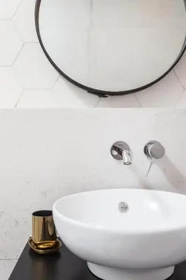 a bathroom with a white sink and a mirror at City of the Kings - Nubium Apartment in Kraków