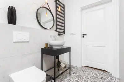 a bathroom with a sink and a mirror at City of the Kings - Nubium Apartment in Kraków