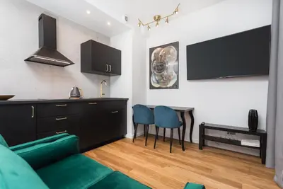a living room with a couch and a table at City of the Kings - Nubium Apartment in Kraków