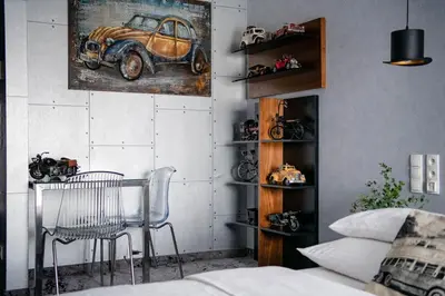 a room with a table and a picture of a car at Hotel Lenart in Wieliczka