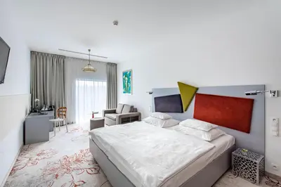 a bedroom with a bed and a couch at Hotel Lenart in Wieliczka