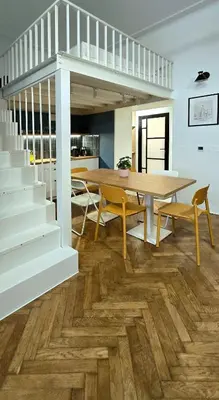 a dining room with a table and a table and chairs at Kurkowa GamaHome Cozy Apartments in Kraków