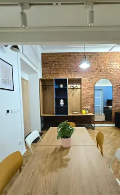 a wooden table with a potted plant on top of it at Kurkowa GamaHome Cozy Apartments in Kraków