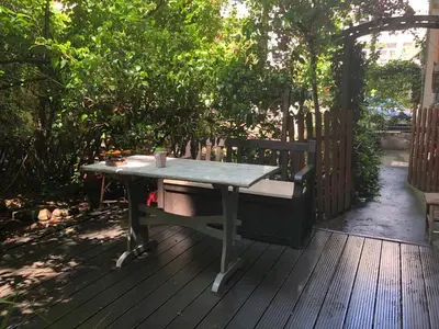a table and bench on a wooden deck at Stylish apartment in Krakow - Old Town in Kraków