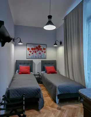 a bedroom with two beds with red pillows at Stylish apartment in Krakow - Old Town in Kraków