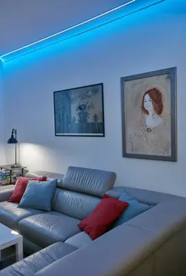 a couch in a living room with a blue light at Stylish apartment in Krakow - Old Town in Kraków