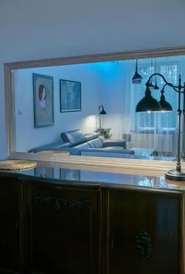 a bedroom with a bed and a large mirror at Stylish apartment in Krakow - Old Town in Kraków