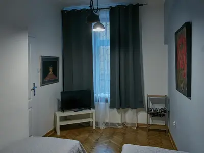 a room with a bed and a tv and a window at Stylish apartment in Krakow - Old Town in Kraków