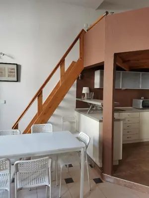a kitchen and dining room with a table and chairs at DaVinci Radziwiłłowska Apartments in Kraków