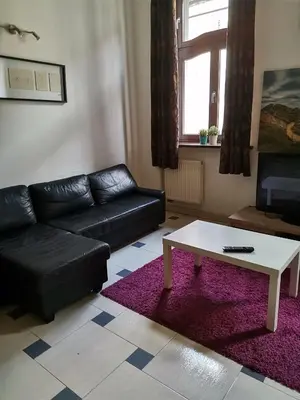 a living room with a couch and a coffee table at DaVinci Radziwiłłowska Apartments in Kraków