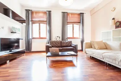 a living room with a couch and a laptop on a coffee table at DaVinci Radziwiłłowska Apartments in Kraków