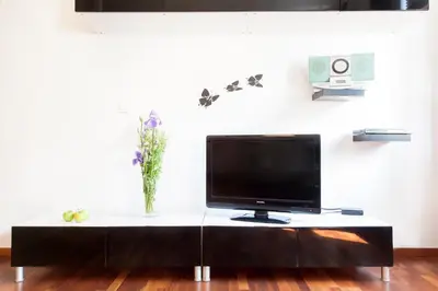 a flat screen tv sitting on top of a table at DaVinci Radziwiłłowska Apartments in Kraków